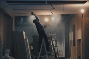 man fitting a suspended ceiling