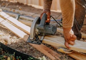 carpenter using circular saw for Exeter building project
