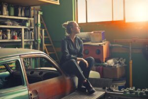 woman sitting on an orange vehicle