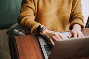 person typing in laptop