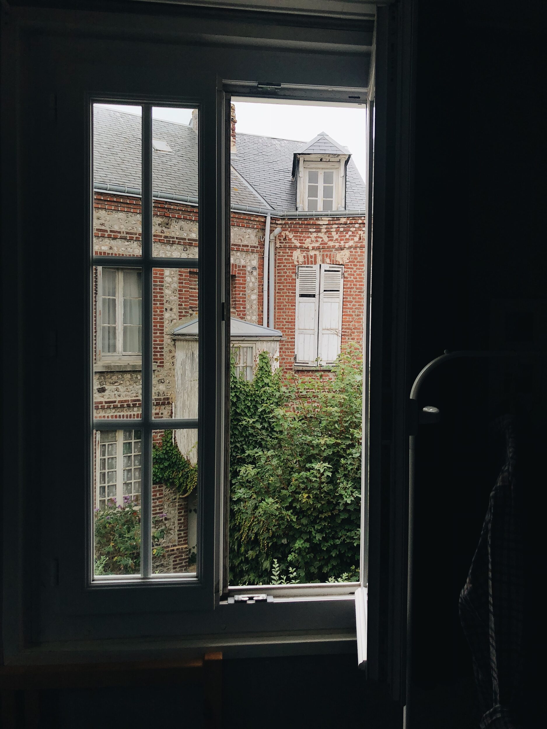open window with old building outside
