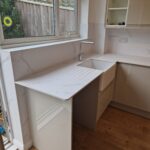 Modern kitchen sink installation with countertop and window view for Cowleys Exeter kitchen refurbishment and design projects